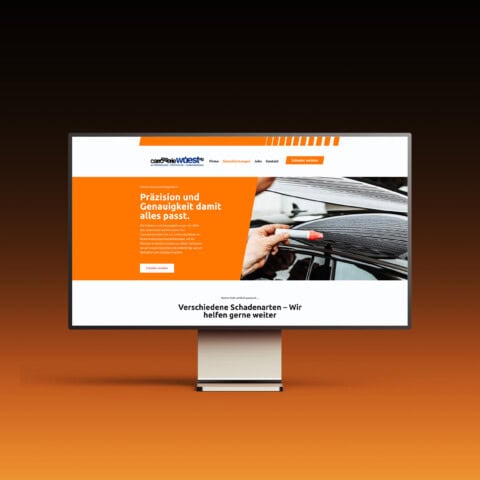 bildschirm mit der startseite der carrosserie wüest auf orangem verlauf