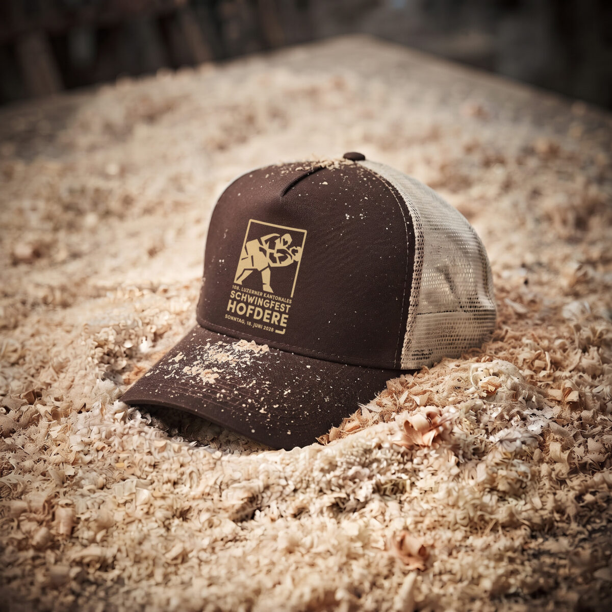 braune cap mit dem logo des schwingfests hofdere im sägemehl